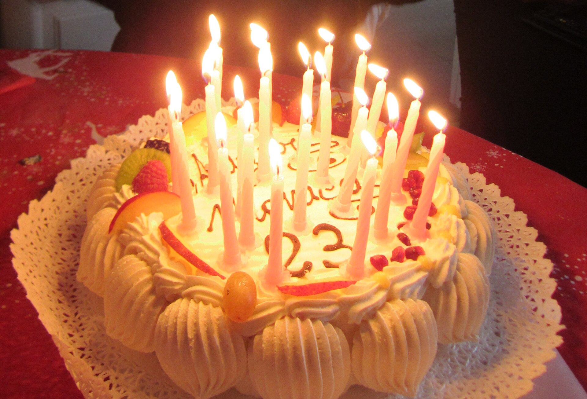 A birthday cake lit with candles